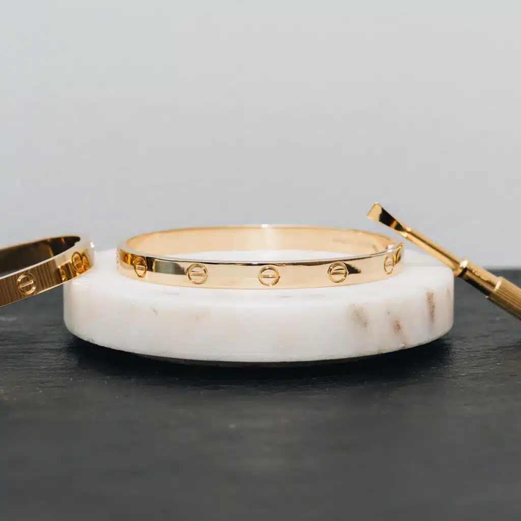 Assorted gold and diamond jewellery pieces arranged on a neutral background