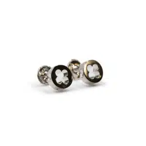 A pair of silver cufflinks with black and white four-leaf clover designs.